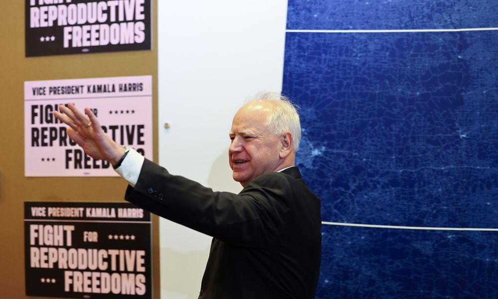 FILE - Minnesota Governor Tim Walz greets reporters before Vice President Kamala Harris speaks at Planned Parenthood, March 14, 2024, in St. Paul, Minn. (AP Photo/Adam Bettcher, File)