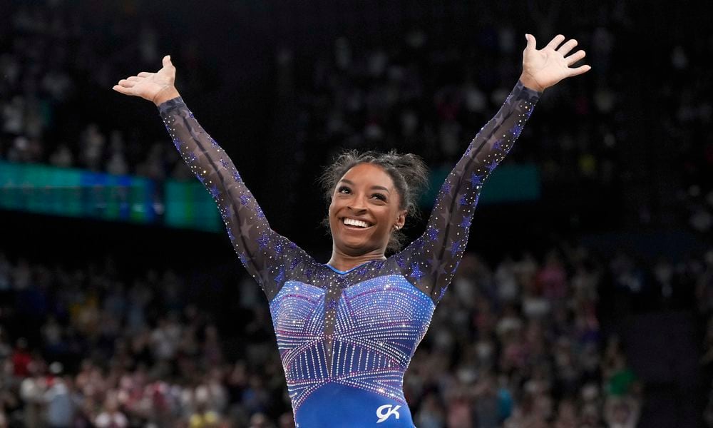 Simone Biles, of the United States, celebrates after performing in the floor exercise during the women's artistic gymnastics all-around finals in Bercy Arena at the 2024 Summer Olympics, Thursday, Aug. 1, 2024, in Paris, France. (AP Photo/Charlie Riedel)