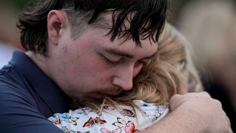 Mourners pray during a candlelight vigil for the slain students and teachers at Apalachee High School, Wednesday, Sept. 4, 2024, in Winder, Ga. (AP Photo/Mike Stewart)