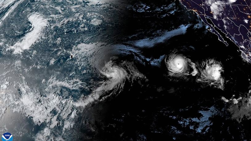 This satellite image provided by the National Oceanic and Atmospheric Administration (NOAA) shows Tropical Storm Hone and Hurricane Gilma located southeast of Hawaii, Thursday, Aug. 22, 2024. (NOAA via AP)