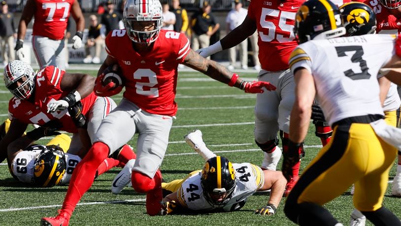 Ohio State receiver Emeka Egbuka, left, runs after catching a pass against Iowa during the first half of an NCAA college football game Saturday, Oct. 22, 2022, in Columbus, Ohio. (AP Photo/Jay LaPrete)