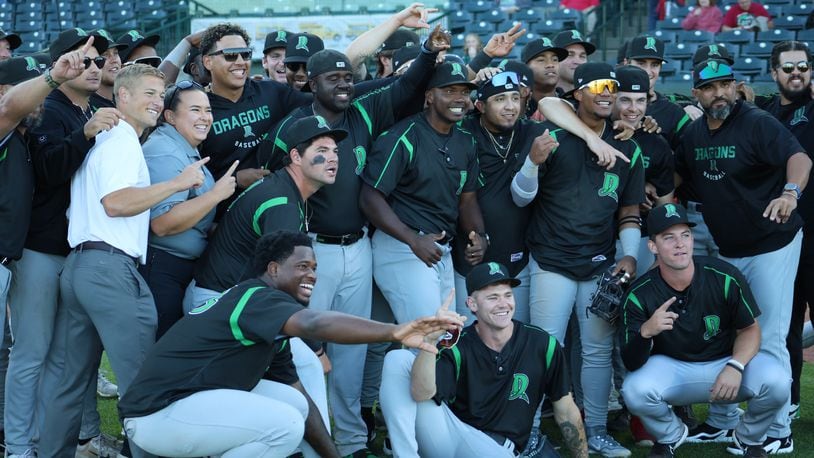 Dayton Dragons players and staff pose for a photo after the Dragons clinched their first playoff berth since 2017 with a 1-0 at Great Lakes on Monday. CONTRIBUTED