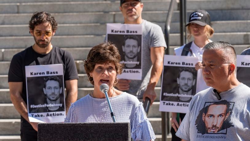 Scarlett Wactor, the mother of late actor Johnny Wactor, speaks during a news conference outside Los Angeles City Hall in Los Angeles, Tuesday, Aug. 13, 2024. asking citizens to help find the suspects that murdered the former "General Hospital" actor. At right, detective Moses Castillo. (AP Photo/Damian Dovarganes)