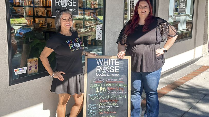 This image released by White Rose Books & More shows bookstore owners Tania Galiñanes, left, and Erin Decker outside their shop in Kissimmee, Fla. on Nov. 4, 2023. (Carlos Galiñanes/White Rose Books & More via AP)