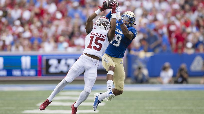 Oklahoma defensive back Kendel Dolby (15) intercepts a ball intended for Tulsa wide receiver Devan Williams (19) during the first half of an NCAA college football game Saturday, Sept. 16, 2023, in Tulsa, Okla. (AP Photo/Alonzo Adams)