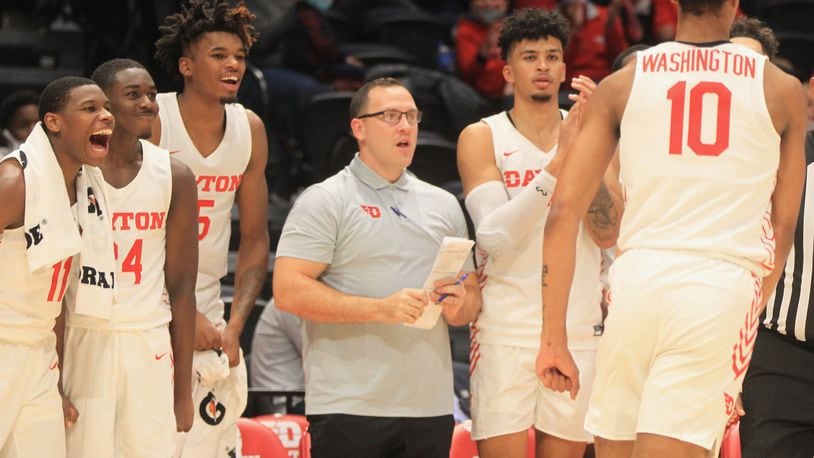 Dayton players and coach Andy Farrell, center, react, after a dunk by Kaleb Washington against Cedarville in an exhibition game on Monday, Nov. 1, 2021, at UD Arena. David Jablonski/Staff