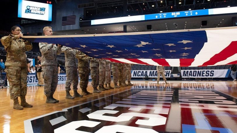 Airmen from Wright-Patterson Air Force Base practice the unfolding and placement of a large, garrison-size American flag at half court prior to the NCAA First Four Tournament at the University of Dayton Arena in Dayton. (U.S. Air Force photo/Michelle Gigante)