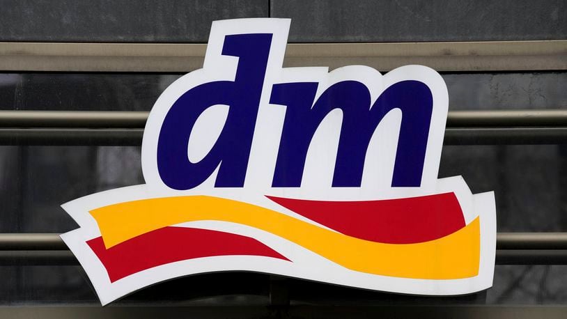 The logo of the drugstore chain 'dm' is pictured on the entrance of a store at the Kurfuerstendamm shopping boulevard in Berlin, Germany, Tuesday, Feb. 1, 2022. (AP Photo/Michael Sohn)