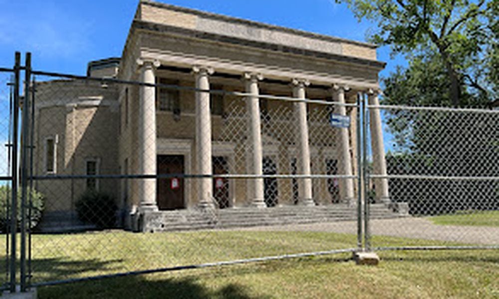 Fencing was being placed around the former First Church of Christ, Scientist, in the South Dayton Rubicon residential neighborhood near the University of Dayton campus Tuesday. Dayton has issued a wrecking permit for the site. THOMAS GNAU/STAFF