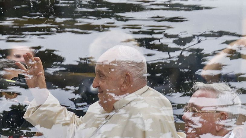 Pope Francis and Archbishop of Luxembourg, Cardinal Jean-Claude Hollerich, right leave in a popemobile the Cercle-Cite convention center in Luxembourg after a meeting with the national authorities and the civil society on the first day of Francis's four-day visit to Luxembourg and Belgium, Thursday, Sept. 26, 2024. (AP Photo/Omar Havana)