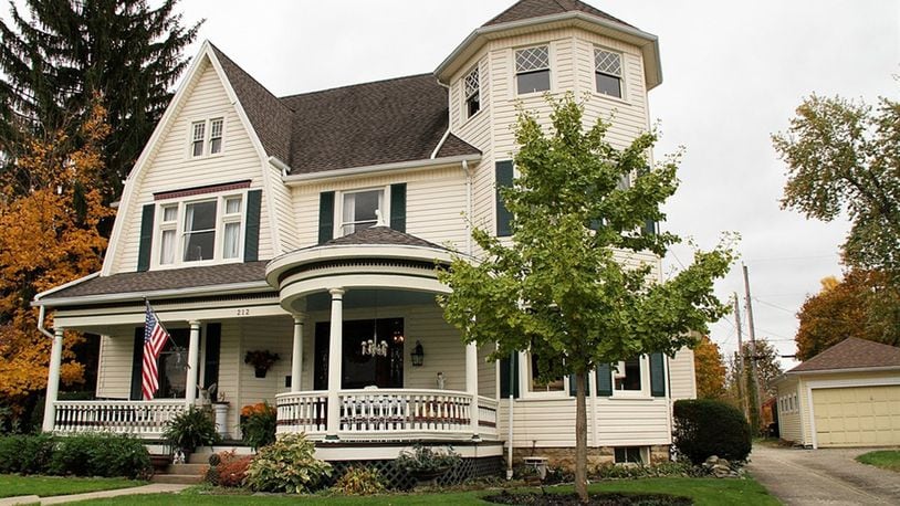 The 3-story home has a covered porch, a private back yard and a 2-story carriage house. The carriage house has 2 overhead garage-doors, double-door entry and walk-up loft storage. CONTRIBUTED PHOTOS BY KATHY TYLER