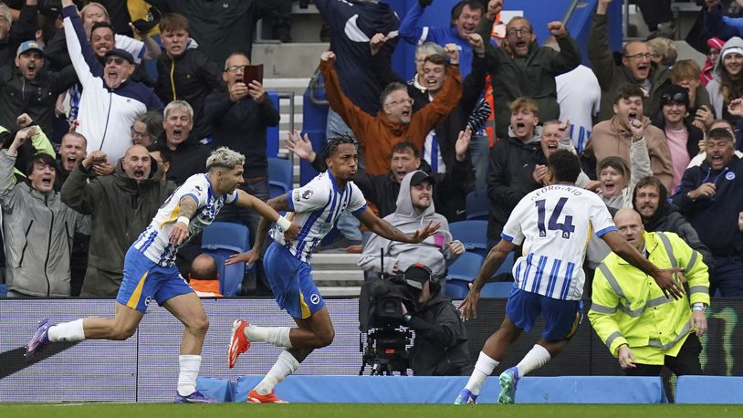 Brighton & Hove Albion's Joao Pedro, center, celebrates scoring with teammates during the English Premier League soccer match between Brighton & Hove Albion and Manchester United at the American Express Stadium, Brighton, England, Saturday Aug. 24, 2024. (Gareth Fuller/PA via AP)