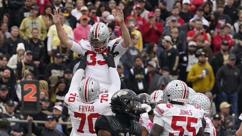 Ohio State quarterback Devin Brown (33) celebrates a touchdown with Josh Fryar (70) during the first half of an NCAA college football game against Purdue, Saturday, Oct. 14, 2023, in West Lafayette, Ind. (AP Photo/Darron Cummings)