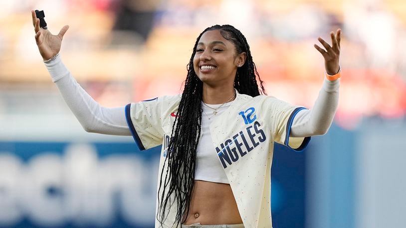 University of Southern California basketball player Juju Watkins gestures after throwing out the ceremonial first pitch prior to a baseball game between the Los Angeles Dodgers and the Los Angeles Angels Saturday, June 22, 2024, in Los Angeles. (AP Photo/Mark J. Terrill)