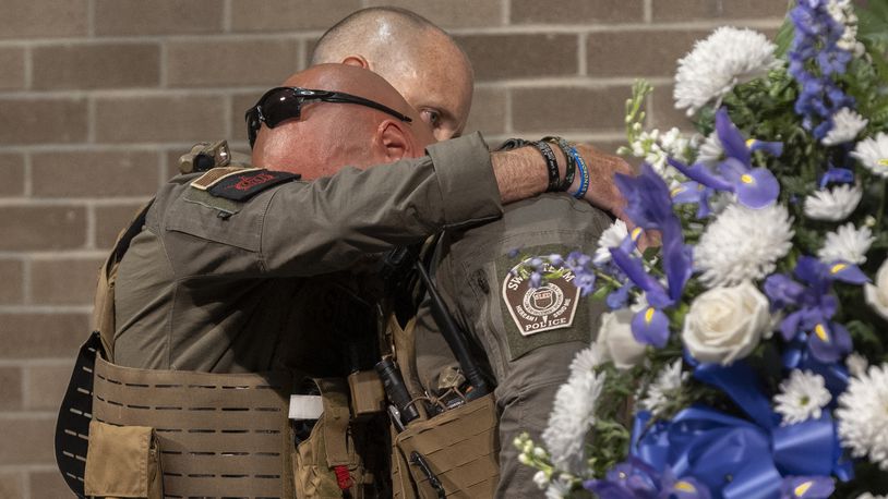 SLED Senior Agent Richard 'Cole' Powell is embraced by teammate Lt. Keith Thrower during a memorial service for Powel's K9 partner, Coba, on Wednesday, June 19, 2024, Columbia, S.C. (Tracy Glantz/The State via AP)