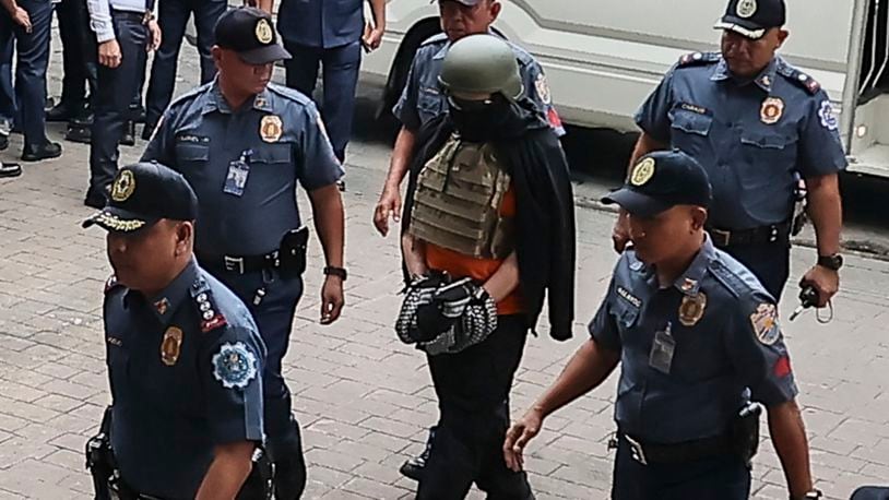 Apollo Carreon Quiboloy, wearing a helmet and flak jacket, a Filipino preacher charged with human trafficking, enters the Pasig Regional Trial Court in Pasig City, Philippines, Friday, Sept. 13, 2024. (AP Photo/Gerard Carreon)