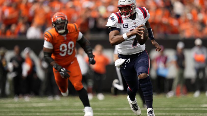 New England Patriots quarterback Jacoby Brissett (7) scrambles up field ahead of Cincinnati Bengals defensive tackle Sheldon Rankins (98) during the first half of an NFL football game, Sunday, Sept. 8, 2024, in Cincinnati. (AP Photo/Carolyn Kaster)