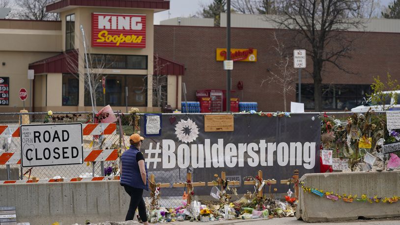 FILE - Tributes cover the temporary fence around the King Soopers grocery store in which 10 people died in a mass shooting in late March on Friday, April 23, 2021, in Boulder, Colo. (AP Photo/David Zalubowski, File)