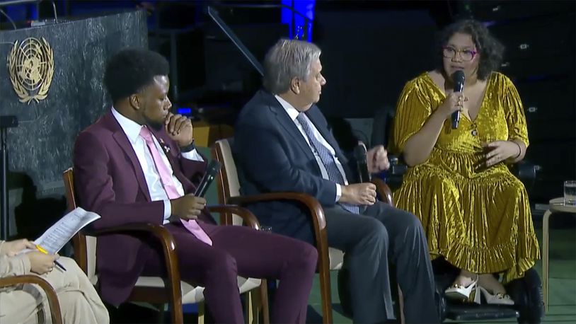 In this photo taken from video, Daphne Frias, right, engages with United Nations Secretary General Antonio Guterres, Friday, Sept. 20, 2024 during a panel discussion at UN headquarters. (UNTV via AP)