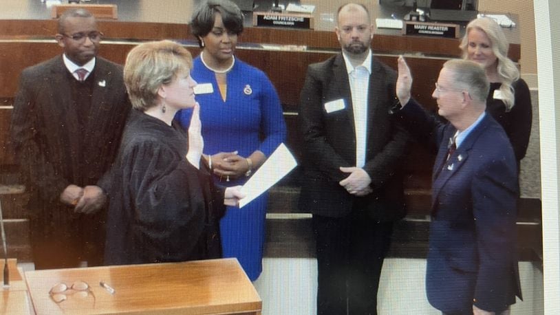 Fairborn Mayor Dan Kirkpatrick (front right) is sworn in Monday night by municipal court Judge Beth Cappelli as city council members look on. NICK BLIZZARD/STAFF