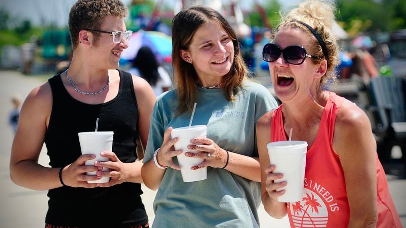 Montgomery County Fair goers, from left, Myles Calondis, Emma and Kimberly Holtzman all agreed Thursday, July 11, 2024 that lemonade was their favorite fair drink. MARSHALL GORBY\STAFF