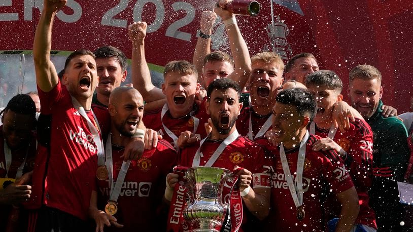 Manchester United's Bruno Fernandes holds the trophy after his team won the English FA Cup final soccer match between Manchester City and Manchester United at Wembley Stadium in London, Saturday, May 25, 2024. Manchester United won 2-1. (AP Photo/Kin Cheung)