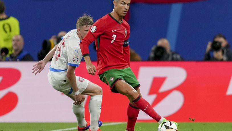 Portugal's Cristiano Ronaldo, right, and Czech Republic's David Jurasek challenge for the ball during a Group F match between Portugal and Czech Republic at the Euro 2024 soccer tournament in Leipzig, Germany, Tuesday, June 18, 2024. (AP Photo/Sunday Alamba)