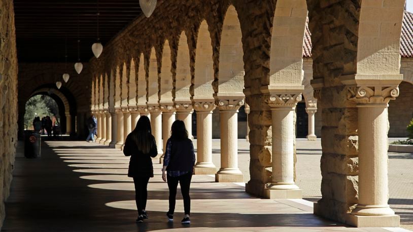 FILE - Students walk on the Stanford University campus on March 14, 2019, in Stanford, Calif. (AP Photo/Ben Margot, File)