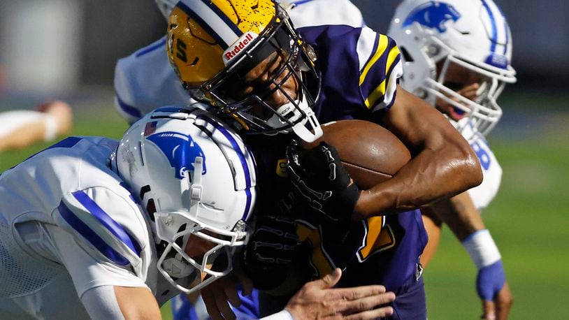 Springfield's Amileo Norvell is pushed out of bounds by Springboro's Evan Weinberg during Friday night's game. BILL LACKEY/STAFF