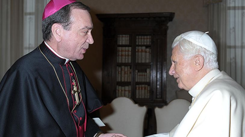 Pope Benedict XVI greets Archbishop Dennis M. Schnurr of Cincinnati during a Feb. 2 meeting with U.S. bishops on their "ad limina" visits to the Vatican. U.S. bishops from Ohio were making their "ad limina" visits to report on the status of their dioceses to the pope and Vatican officials. (CNS photo/L'Osservatore Romano) (Feb. 2, 2012)