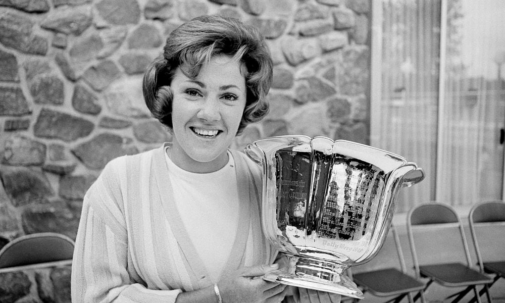 FILE - Susie Maxwell holds the silver trophy after winning the 36th annual Women's Western golf tournament, June 14, 1965, in Chicago. (AP Photo/Larry Stoddard, File)