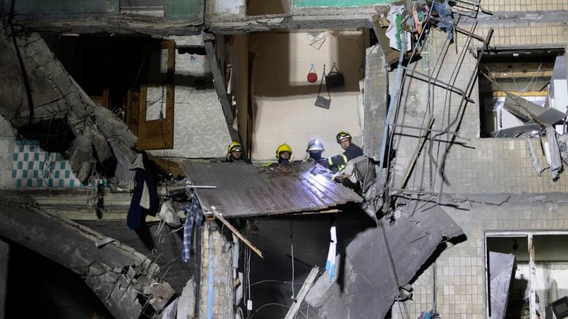 Rescue workers clear the rubble inside a building damaged by a Russian airstrike in Kharkiv, Ukraine, Thursday Oct. 3, 2024. (AP Photo/Yevhen Titov)