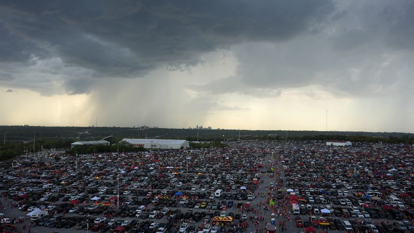 Clouds are seen in the distance as fans fill the parking lot outside Arrowhead Stadium before the start of an NFL football game between the Kansas City Chiefs and the Baltimore Ravens Thursday, Sept. 5, 2024, in Kansas City, Mo. (AP Photo/Charlie Riedel)