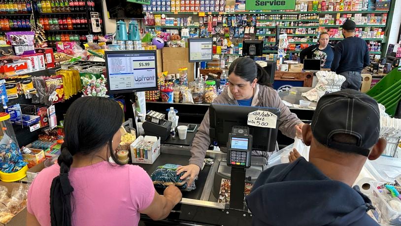 FILE - Cashier Rosa Dilone helps customers at Mi Tierra Supermarket in Hazleton, Pa., on May 16, 2024. (AP Photo/Mark Scolforo, File)