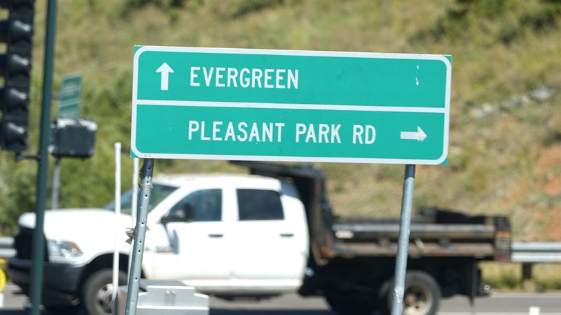 A sign off Highway 285 points motorists to Pleasant Park Road where a teenager, who was scouting for a location for lakeside homecoming photos, was shot in the face earlier this week by a town councilman, Friday, Sept. 13, 2024, near Conifer, Colo. (AP Photo/David Zalubowski)