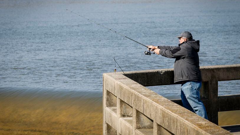 Arley Cope fishes during his lunch break at the Great Miami River low level dam along Neilan Boulevard near Lodder Park Tuesday, Feb. 6, 2024, in Hamilton. NICK GRAHAM/STAFF