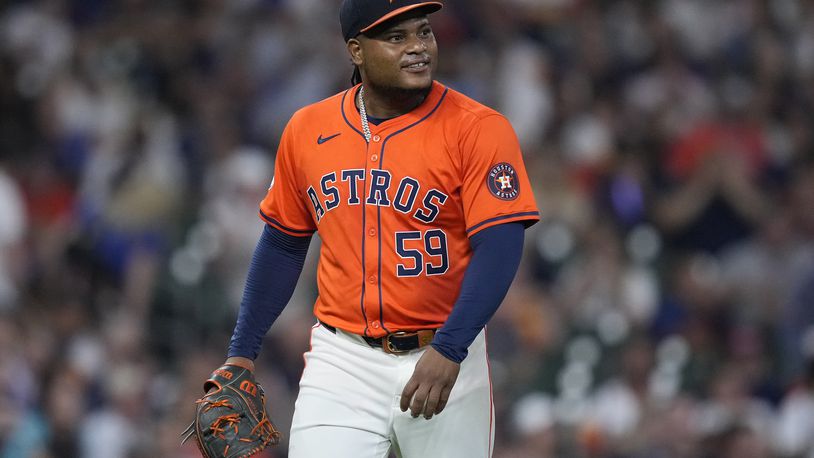 Houston Astros starting pitcher Framber Valdez smiles after shortstop Jeremy Peña threw out Kansas City Royals' Freddy Fermin on a ground ball during the fifth inning of a baseball game Friday, Aug. 30, 2024, in Houston. (AP Photo/Kevin M. Cox)