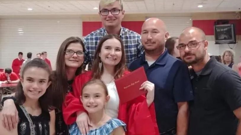 Cynthia Steele, second from left, with her children Abbie, bottom left; Aubrie, bottom center; Ellie, center; Nathan, top center; Erik, far right; and her husband, Chris, second from right. CONTRIBUTED