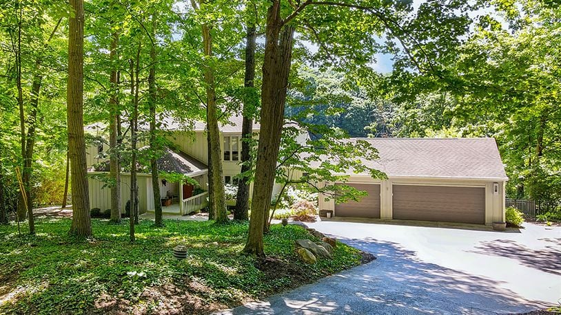 The 3-story, cedar-sided home has about 4,670 sq. ft. of living space. The 0.77-acre property overlooks the sixth fairway of the Dayton Country Club golf course. Extensive landscaping blends evergreens, hardwoods, perennials and natural grasses to provide privacy with a view. CONTRIBUTED PHOTO