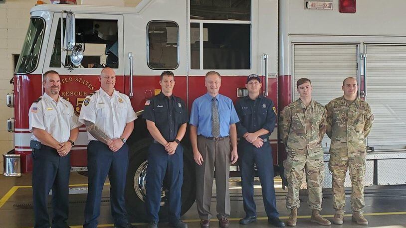 Stopping at Fire Station 1 at Wright-Patterson Air Force Base, Ken Wright (center) from the Defense Contract Management Agency Dayton office wanted to personally thank first responders who saved his life this summer. Wright spoke with each of the first responders, shook their hands and posed for pictures with them beside the Rescue 15. From left to right are Dispatch Supervisor Cory Downey, Assistant Chief Bryan Weeks, Firefighter Greg Arnold, Ken Wright, Firefighter Brandon Wheeler and Senior Airman Josh Lynn and Senior Airman Stephen Cotto-Nunez from the 88th Medical Operations Squadron. (Courtesy photo)