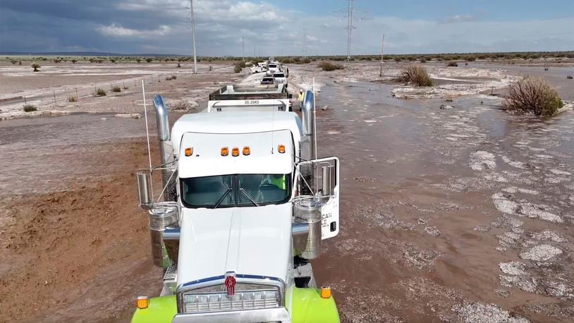 In this photo provided by Mike Bischoff, Vehicles are lined up after flash flooding along Highway 42 near Willard, N.M., on Wednesday, June 19, 2024. (Mike Bischoff @blueskyproductionsutah via AP)