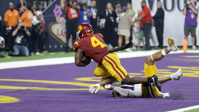 Southern California running back Woody Marks (4) scores the winning touchdown past LSU safety Dashawn Spears (10) during the second half of an NCAA college football game Sunday, Sept. 1, 2024, in Las Vegas. (AP Photo/Steve Marcus)