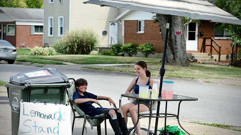 A way to beat the heat and make money Emma Guernsey, age 11 and Jazlynn Hambidge, age 13, set up a lemonade stand on Kaufman Avenue in Fairborn, Tuesday, June 18, 2024. MARSHALL GORBY \STAFF