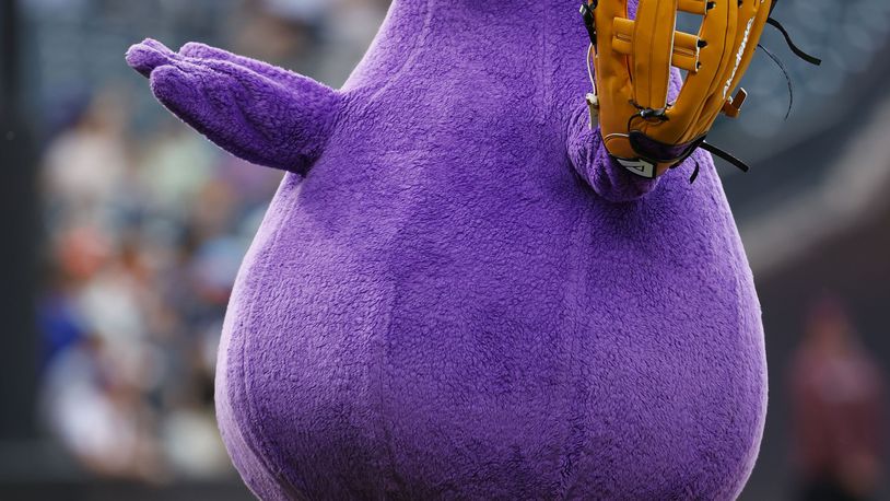 FILE - McDonald's character Grimace throws out a ceremonial first pitch before a baseball game between the Miami Marlins and the New York Mets, June 12, 2024, in New York. (AP Photo/Rich Schultz, File)