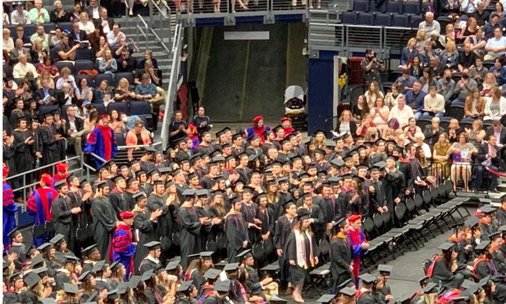 Another group of students take their place in line to receive their diplomas during Sunday's graduation ceremonies at the University of Dayton. ED RICHTER/STAFF