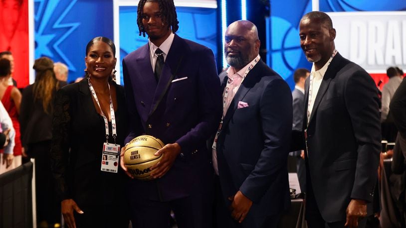 DaRon Holmes II poses for a photo with his mom Tomika, dad DaRon Sr. and Dayton's Anthony Grant before the NBA Draft on Wednesday, June 26, 2024, at the Barclays Center in Brooklyn, N.Y. David Jablonski/Staff