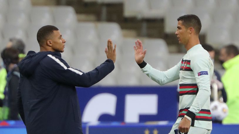 FILE - In this Sunday, Oct. 11, 2020 file photo France's Kylian Mbappe and Portugal's Cristiano Ronaldo, right, greet each other before the Nations League soccer match between France and Portugal at the Stade de France in Saint-Denis, north of Paris, France. Cristiano Ronaldo vs. Kylian Mbappe is not just a clash of soccer icons but a clash of generations. They’ll go head to head when Portugal plays France in the Euro 2024 quarterfinals on Friday and their heavyweight meeting just got a little bit bigger after Ronaldo said this would be his last European Championship. (AP Photo/Thibault Camus, File)
