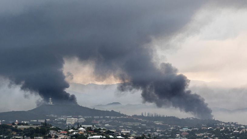 FILE - Smoke rises during protests in Noumea, New Caledonia, on May 15, 2024. Global nickel prices have soared since deadly violence erupted in the French Pacific territory of New Caledonia. (AP Photo/Nicolas Job, File)