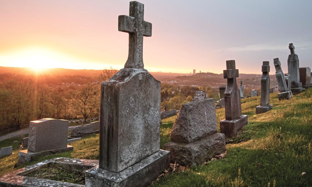 FILE - The sun rises on St. Mary's Cemetery, April 19, 2019, in McKees Rocks, Pa. (Andrew Rush/Pittsburgh Post-Gazette via AP, File)