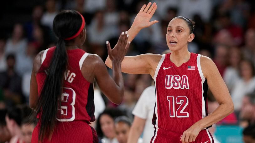 United States' Diana Taurasi (12) celebrates with United States' Jackie Young (13) during a women's quarterfinal game against Nigeria at Bercy Arena at the 2024 Summer Olympics, Wednesday, Aug. 7, 2024, in Paris, France. (AP Photo/Mark J. Terrill)